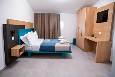 a bedroom with a bed and a television in it at Villa Luxury Eden di Sofia in Partinico