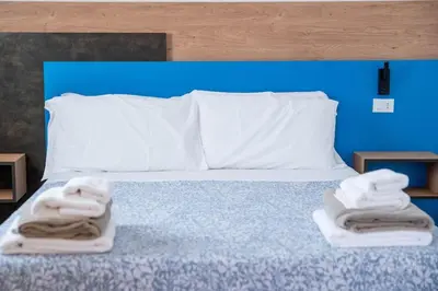 a bedroom with a bed with towels on it at Villa Luxury Eden di Sofia in Partinico