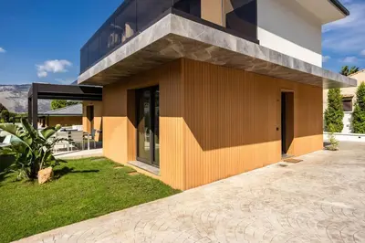 a house with a brown and black facade at Luxury Jacuzzi Villa Nettuno in Palermo