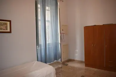 a bedroom with a bed and a dresser and a window at Goethe's Sicily trip - Palermo in Palermo