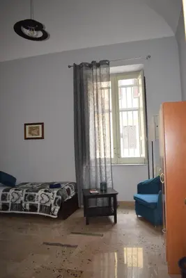 a living room with a bed and a window at Goethe's Sicily trip - Palermo in Palermo
