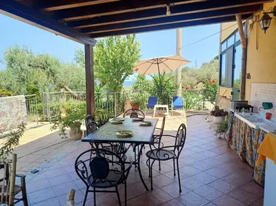 a living room with a couch and a window at Il giardino degli ulivi Villa indipendente a 5 Min mare in Trabia