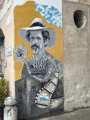 a painting of a man in a hat on a wall at mastro casa vacanza in Palermo