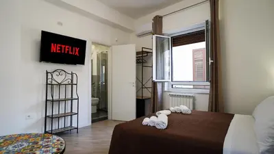 a bedroom with a bed with towels on it at Bieddu Suites - Palermo City Center in Palermo