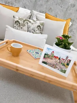 a wooden coffee table on a couch with a coffee cup at Kalos suite in Palermo