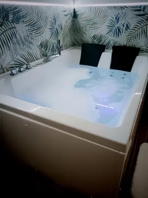 a white bath tub sitting in a room at Kalos suite in Palermo