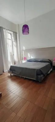 a bedroom with a bed and a wooden floor at Il Quadrifoglio Room& Suite in Palermo