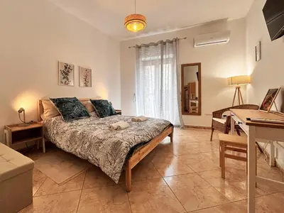 a bedroom with a bed and a desk in a room at Casa Cassarelli in Centro in Palermo