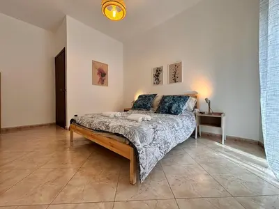 a bedroom with a large bed in a room at Casa Cassarelli in Centro in Palermo