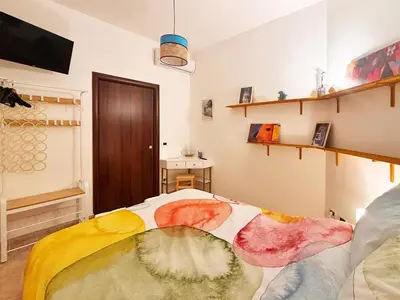 a room with a bed with a colorful blanket at Casa Cassarelli in Centro in Palermo