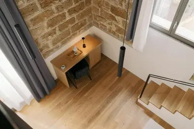 an overhead view of a room with a table and a brick wall at Spasimo Hôtellerie in Palermo