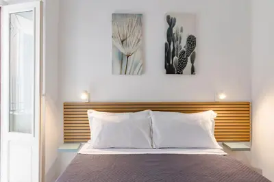a bedroom with a bed and two pictures on the wall at GuestHost - Mezzojuso Central Apartment near Via Roma in Palermo