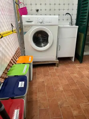 a washer and dryer in a room with a tile floor at Vito's holiday house in Palermo