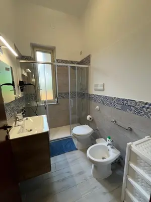 a bathroom with a toilet and a shower and a sink at Vito's holiday house in Palermo