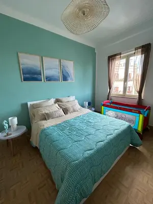 a bedroom with a large bed with a blue wall at CalaMia in Palermo