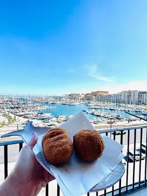 two donuts sitting on a napkin on a balcony at CalaMia in Palermo