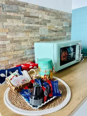 a basket of food on a counter next to a microwave at CalaMia in Palermo