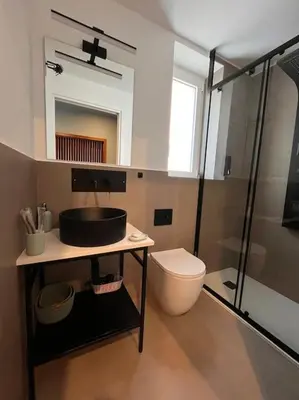 a bathroom with a sink and a toilet and a shower at Cantù Home in Misilmeri