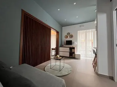 a living room with a couch and a table at Cantù Home in Misilmeri