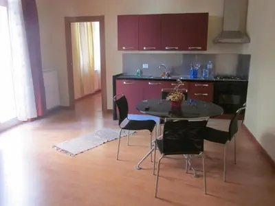 a kitchen with a table and chairs in a room at Panormus Home&Apartaments in Palermo