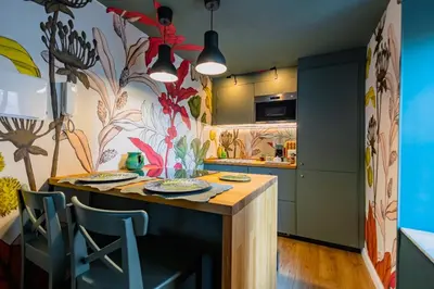 a kitchen with a table and chairs in a room at Green Luxury Apartment in Palermo