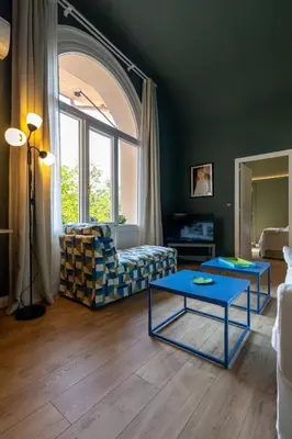 a living room with a couch and a table at Green Luxury Apartment in Palermo