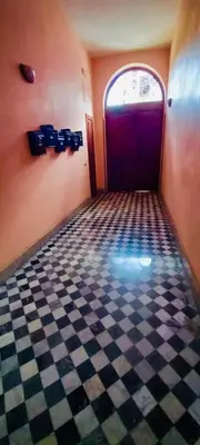 a room with a red door and a checkered floor at Accasetta in Palermo