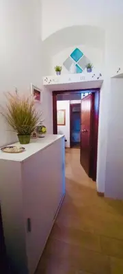 a room with a kitchen with a counter and a hallway at Accasetta in Palermo