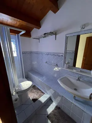 a bathroom with a sink and a toilet and a mirror at Rustico San Leonardo in Cinisi