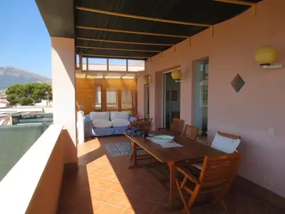 a living room with a wooden table and chairs at Casa Allegra Mondello in Palermo