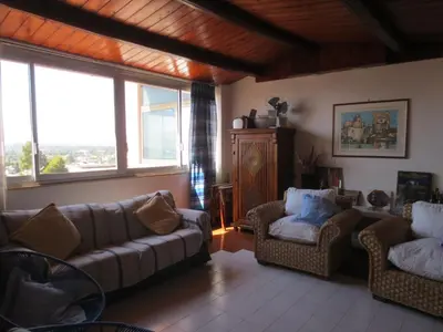 a living room with couches and chairs and windows at Casa Allegra Mondello in Palermo