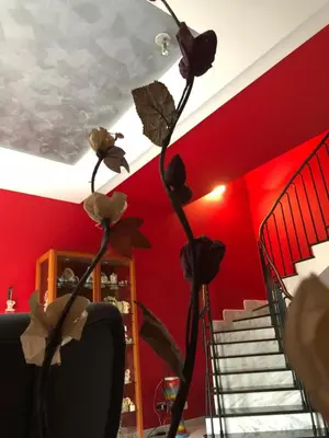 a room with red walls and a staircase with flowers at El Nur Bed & Breakfast in San Vito lo Capo
