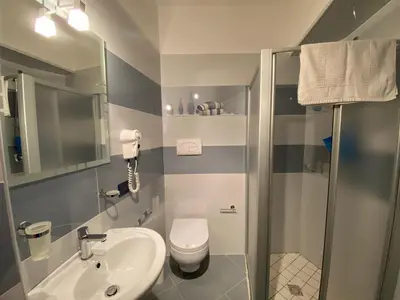 a bathroom with a toilet and a sink and a shower at El Nur Bed & Breakfast in San Vito lo Capo