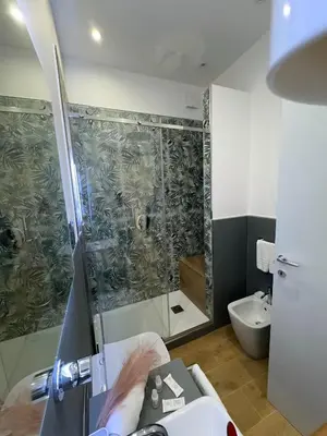 a bathroom with a shower and a sink and a toilet at B&B Central Station in Palermo