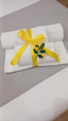 a white towel with yellow bows on a table at B&B Central Station in Palermo