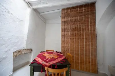 a room with a table with a red blanket on it at Le 4 Stagioni-nelcuorediCorleone in Corleone
