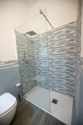 a bathroom with a glass shower with a toilet at Le 4 Stagioni-nelcuorediCorleone in Corleone