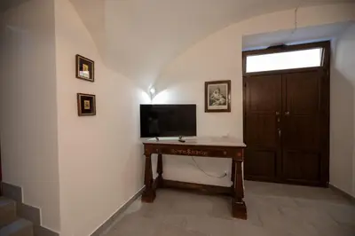 a room with a desk with a television and a door at Le 4 Stagioni-nelcuorediCorleone in Corleone