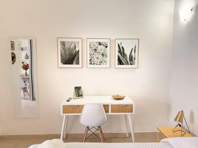 a white desk in a room with four pictures on the wall at L'alcova di nonna Caterina - Guest House in Terrasini