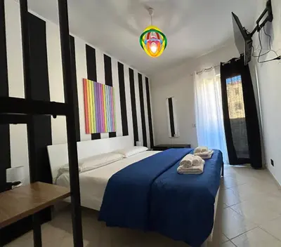 a bedroom with a bed with two towels on it at Aurora house in Palermo