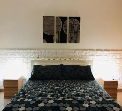 a bedroom with a bed and two pictures on the wall at Casa Vacanze Kristel in Balestrate