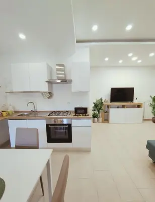a white kitchen with a sink and a stove at PaMa House comfort e relax a due passi dal centro in Palermo