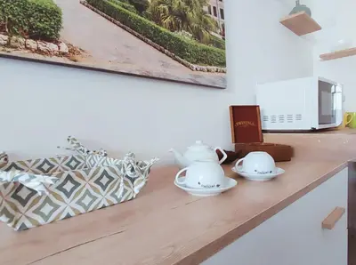 a kitchen counter with two tea cups and a microwave at PaMa House comfort e relax a due passi dal centro in Palermo