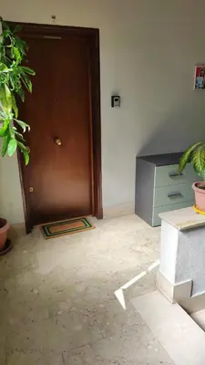 a room with a brown door and a desk at PaMa House comfort e relax a due passi dal centro in Palermo