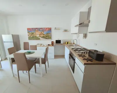 a kitchen with a table and a dining room at PaMa House comfort e relax a due passi dal centro in Palermo