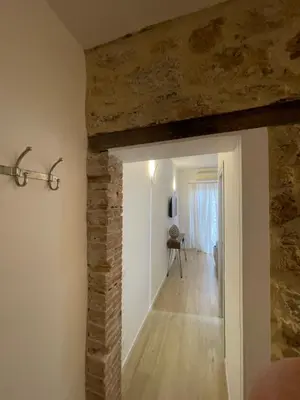 a room with a brick wall and a hallway at Calderai Suite centro storico Palermo in Palermo