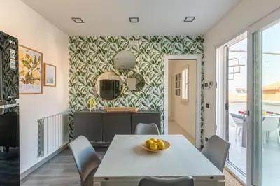 a kitchen and dining room with a table and chairs at La Dolce Vista - Magaggiari in Terrasini