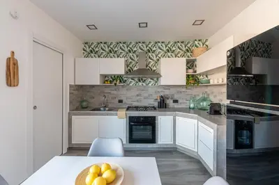a kitchen with a table with a bowl of fruit on it at La Dolce Vista - Magaggiari in Terrasini