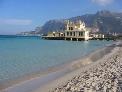 a building on the beach next to the water at Casa Vacanze Daniele in Balestrate