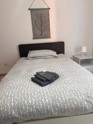 a bed with two towels sitting on top of it at Casa Vacanze Daniele in Balestrate